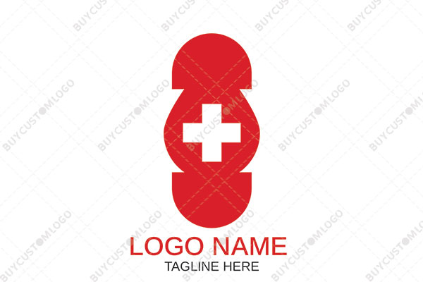 abstract pill/bandage with a red cross logo