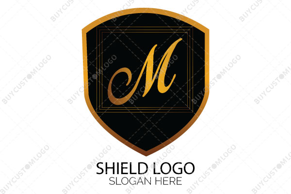 letter m in a shield golden and black logo