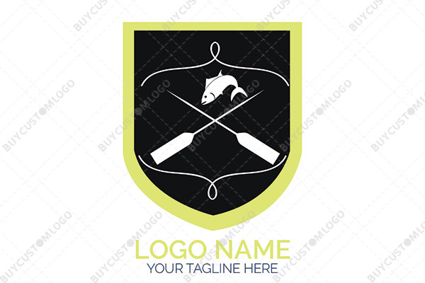 harpoons, fish and rope in a shield logo