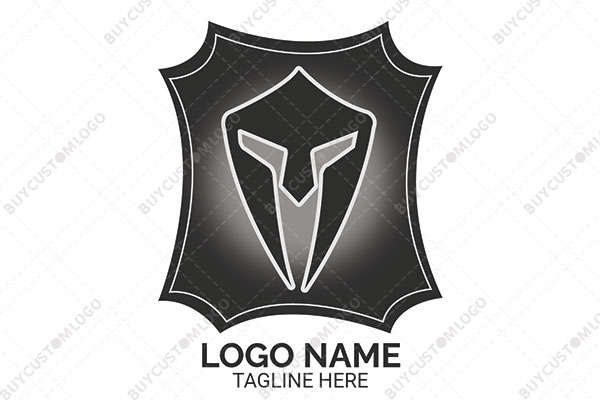 alien face spartan mask in a badge logo